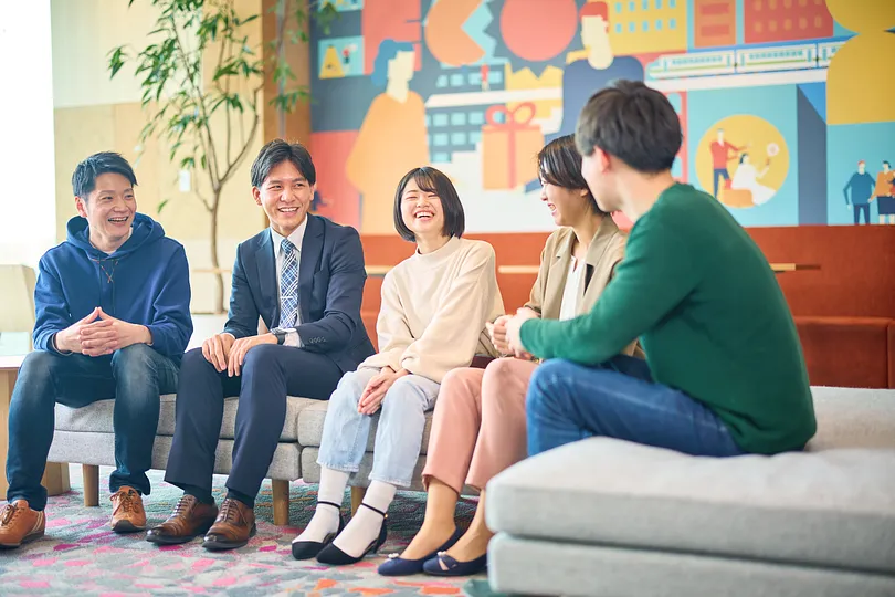 People sitting and laughing on a sofa