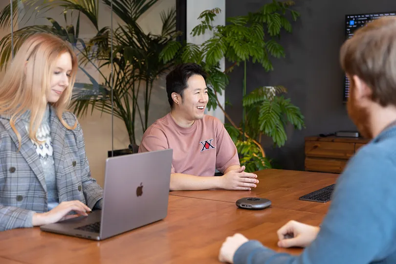 Three people at a conference table