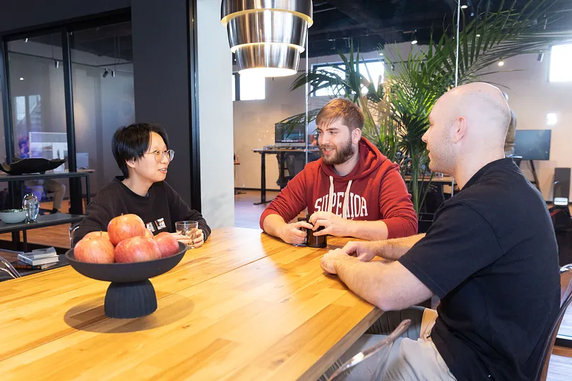 Three people chatting at a table