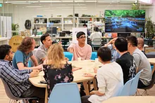 People sitting around a table in an animated discussion