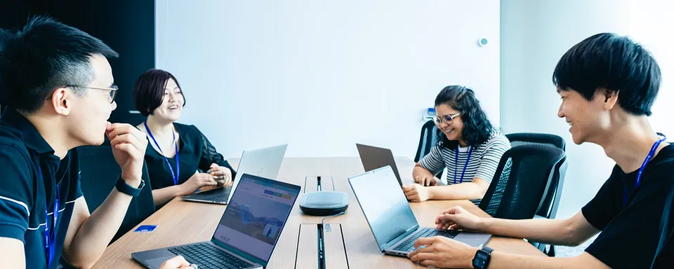Four people having a meeting