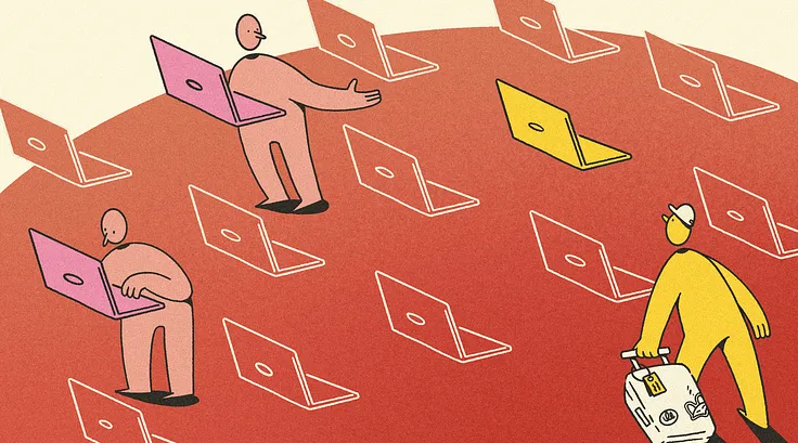 Many laptops but only a couple occupied. A person with a suitcase walks towards them.