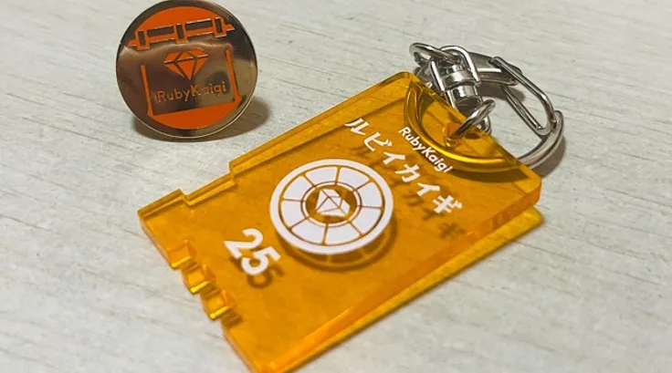 RubyKaigi 2025 orange acrylic charm and pin badge