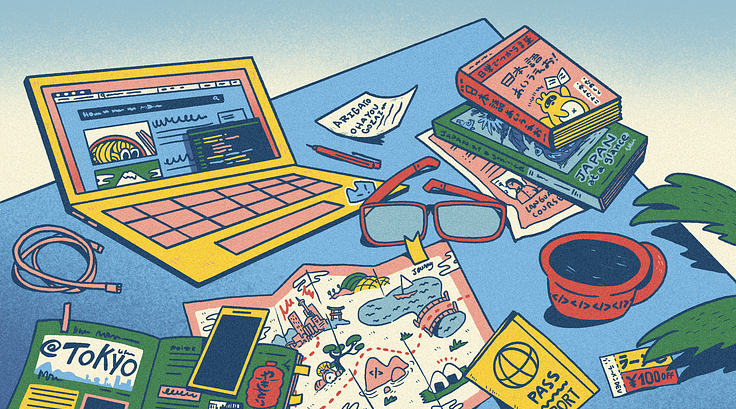 A laptop, map, and books about Japan.