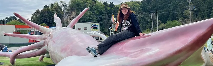 Ann on  playground equipment shaped like a giant squid.