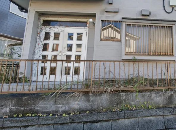 The front door was covered in vines before being sold.
